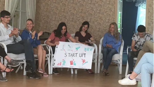 Start-up training participants with their project poster